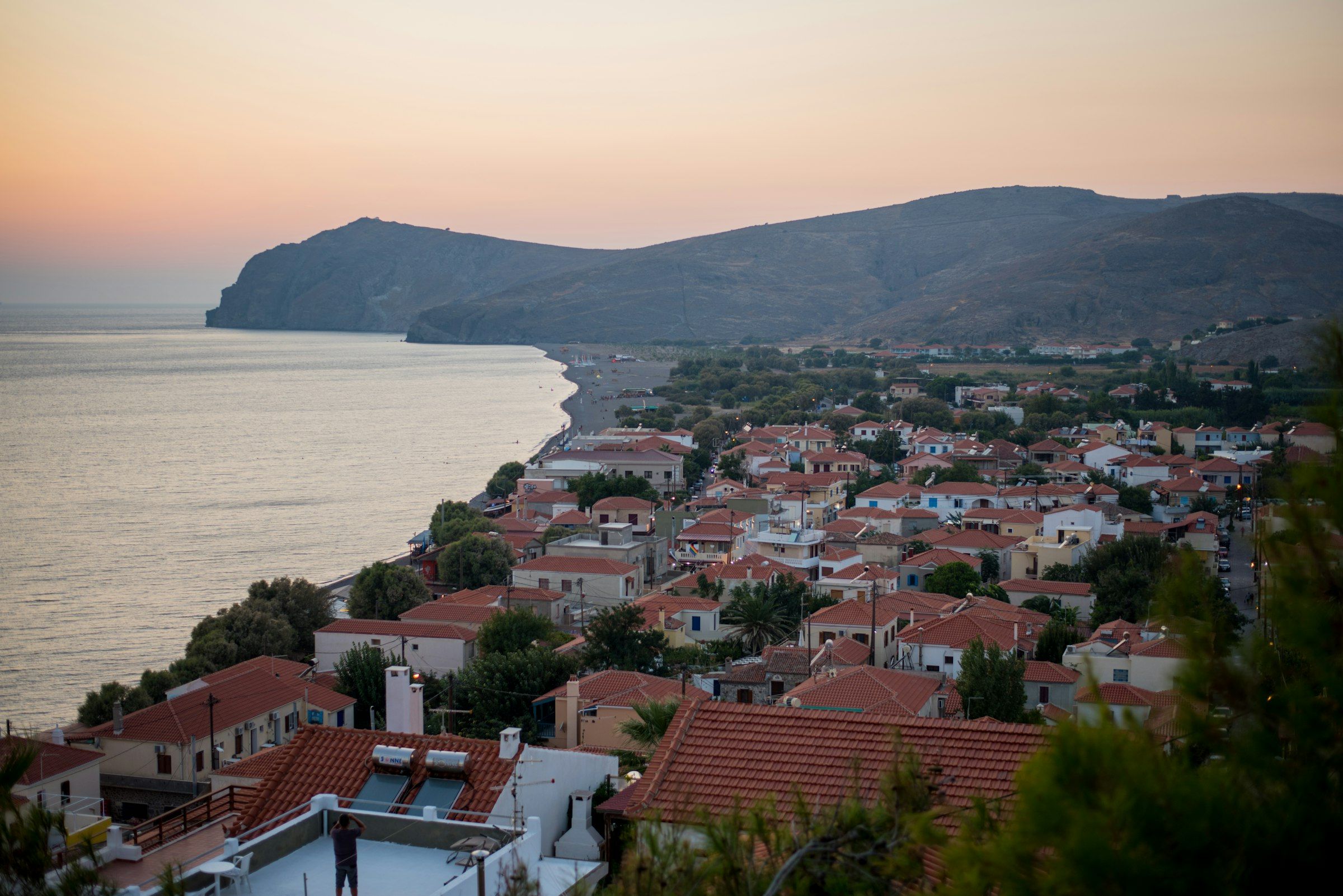 A red-roofed coastal village from above